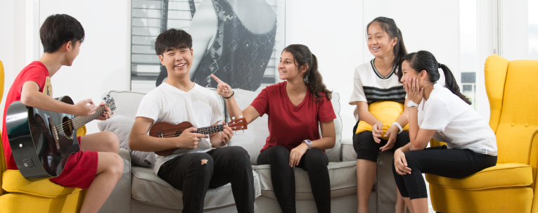 group of students playing guitar and having fun